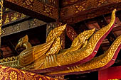 Wat Xieng Thong temple in Luang Prabang, Laos. The wooden pipes in the shape of a naga used during Lao New Year to pour water on a Buddha image. 